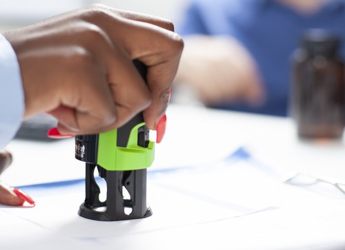 Stamp being applied to paperwork