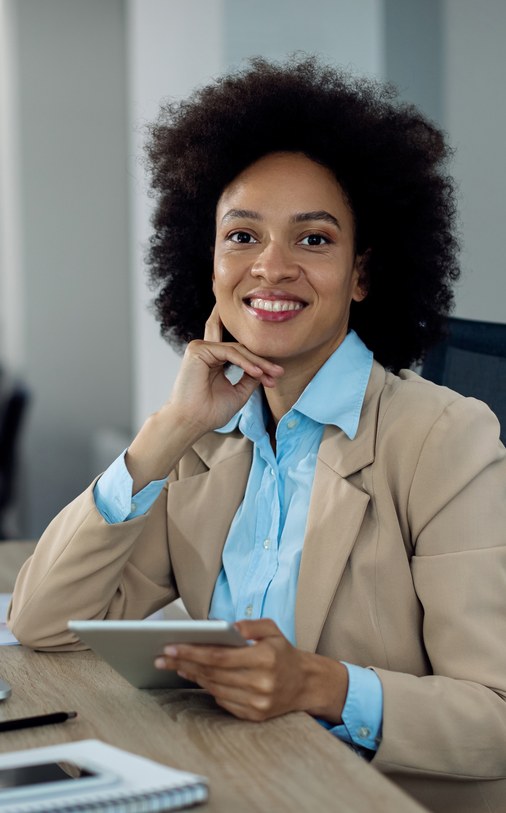 Professional using a tablet at an office desk