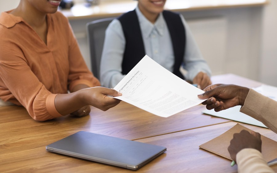 Document being handed over during a meeting