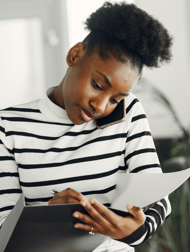 Woman discussing documents by phone