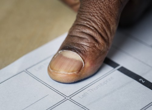 Fingerprint being taken on a paper form